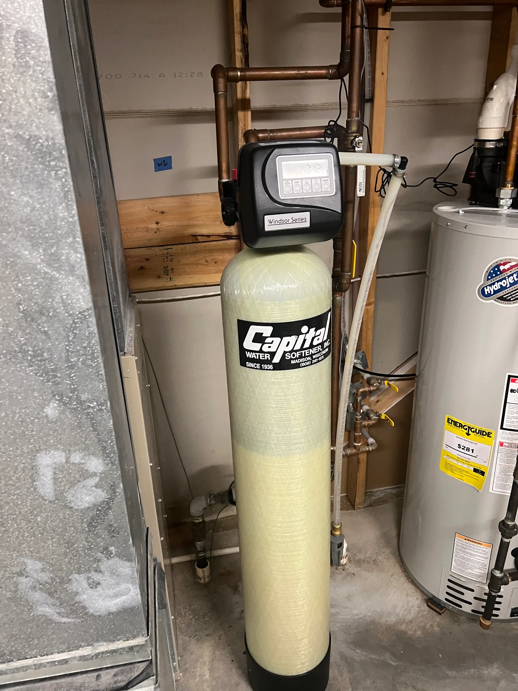 Capital water softener system with Windsor Series control valve in basement utility room.