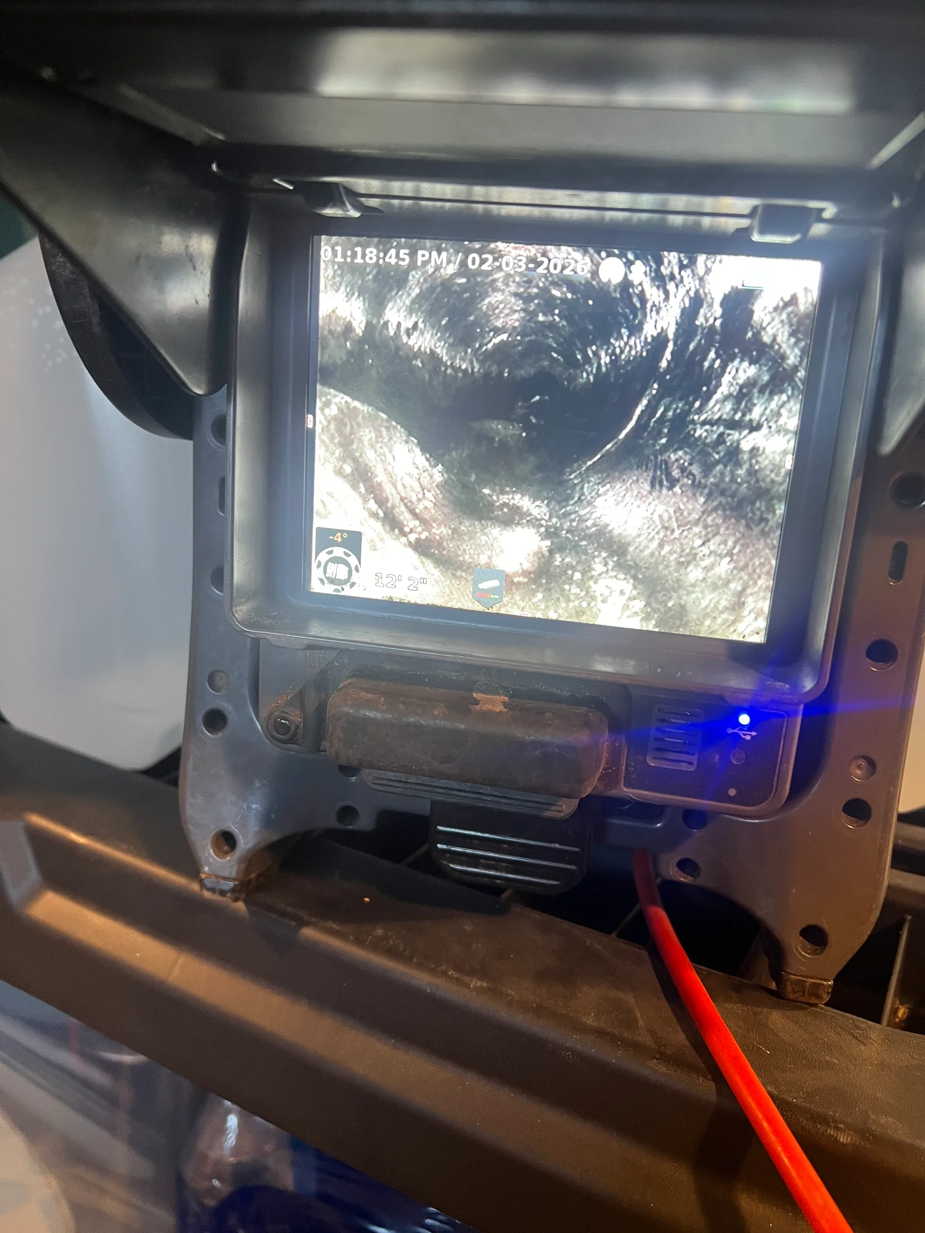 Plumbing inspection camera display showing interior pipe view with timestamp and temperature reading.